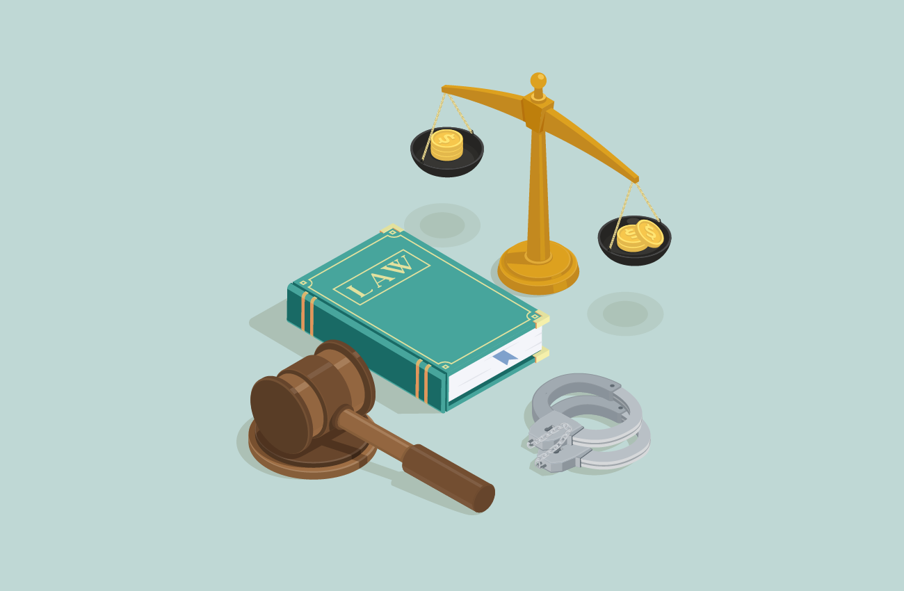 Law book, gavel, scale and handcuffs